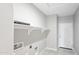 Laundry room featuring tile flooring, shelving, and a laundry hookups at 20411 W Mountain Sage W Dr, Buckeye, AZ 85326