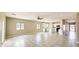Spacious living room with an open floor plan to the kitchen, tile floors, and natural light from the windows at 20411 W Mountain Sage W Dr, Buckeye, AZ 85326