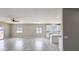 Spacious living room with tile flooring, recessed lighting, a ceiling fan and a view into the kitchen at 20411 W Mountain Sage W Dr, Buckeye, AZ 85326