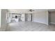 Open floor plan with a kitchen and living room featuring tile floors, neutral paint, and recessed lighting at 20411 W Mountain Sage W Dr, Buckeye, AZ 85326