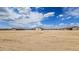 Wide aerial view of multiple homes in a desert landscape under a blue sky at 20419 W Mountain Sage Dr, Buckeye, AZ 85326