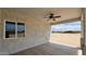 Covered back porch with a ceiling fan offers an inviting space to enjoy the outdoors at 20419 W Mountain Sage Dr, Buckeye, AZ 85326