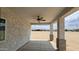 Covered back porch with a ceiling fan, perfect for relaxing and enjoying the outdoors at 20419 W Mountain Sage Dr, Buckeye, AZ 85326