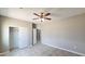 Comfortable bedroom with ceiling fan, closet, neutral paint, and access to the hallway at 20419 W Mountain Sage Dr, Buckeye, AZ 85326
