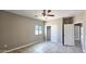 This bedroom features tile flooring, a ceiling fan, a window, and a closet at 20419 W Mountain Sage Dr, Buckeye, AZ 85326