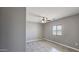 Clean and bright bedroom with a ceiling fan and tiled flooring at 20419 W Mountain Sage Dr, Buckeye, AZ 85326