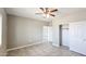 This is a spacious bedroom with tiled floor, ceiling fan, and closet with sliding doors at 20419 W Mountain Sage Dr, Buckeye, AZ 85326