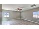 A bright bedroom with tile floor features two windows to let in natural light and ventilation at 20419 W Mountain Sage Dr, Buckeye, AZ 85326