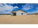 Exterior view of a single-story home showing the neutral stucco and covered patio at 20419 W Mountain Sage Dr, Buckeye, AZ 85326