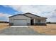 Charming single-story home with a neutral color palette, two-car garage, and desert landscape at 20419 W Mountain Sage Dr, Buckeye, AZ 85326