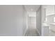 This hallway features tile floors and neutral paint, leading to a bright, open living space at 20419 W Mountain Sage Dr, Buckeye, AZ 85326