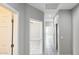 Bright hallway with white trim and neutral paint creates a seamless transition between rooms at 20419 W Mountain Sage Dr, Buckeye, AZ 85326