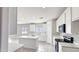 Bright kitchen with white cabinets, island with countertop, and stainless steel appliances at 20419 W Mountain Sage Dr, Buckeye, AZ 85326