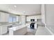 Modern kitchen with white cabinetry, countertops, stainless steel appliances and a large island at 20419 W Mountain Sage Dr, Buckeye, AZ 85326