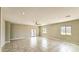 Spacious living room with tiled floors, lots of light, and a ceiling fan at 20419 W Mountain Sage Dr, Buckeye, AZ 85326