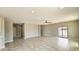 Expansive living room featuring tiled floors, ample lighting, and an open floor plan at 20419 W Mountain Sage Dr, Buckeye, AZ 85326