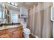 Well-lit bathroom featuring a granite countertop, a tiled floor and a shower with a curtain at 2101 S Meridian Rd # 250, Apache Junction, AZ 85120
