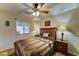 Bedroom featuring a bed with a colorful quilt, two lamps, and a window with coverings at 2101 S Meridian Rd # 250, Apache Junction, AZ 85120