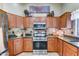 Well-equipped kitchen featuring wood cabinetry, stainless steel appliances, and granite countertops at 2101 S Meridian Rd # 250, Apache Junction, AZ 85120