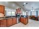 Kitchen with stainless steel appliances, brown cabinetry, decorative backsplash and view to the dining area at 2101 S Meridian Rd # 250, Apache Junction, AZ 85120