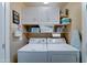 Practical laundry room with white appliances and storage cabinets at 2101 S Meridian Rd # 250, Apache Junction, AZ 85120