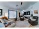 Inviting living room with modern fireplace, leather chairs, ceiling fan, and bright natural light at 2101 S Meridian Rd # 250, Apache Junction, AZ 85120
