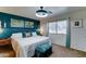 Cozy bedroom with a plush bed, teal accent wall, and warm ambient lighting for relaxing at 2101 S Meridian Rd # 250, Apache Junction, AZ 85120