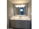 Bathroom with marble countertop vanity, sink, and a large mirror with modern lighting at 2121 W Royal Palm Rd # 1014, Phoenix, AZ 85021