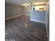 Open living room featuring grey walls and hardwood floors at 2121 W Royal Palm Rd # 1014, Phoenix, AZ 85021