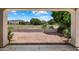 Serene backyard featuring decorative gravel, lush greenery, and views of a neighboring grassy field at 21675 N 61St Ave, Glendale, AZ 85308