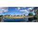 Scenic view of a lakeside community featuring lush landscaping and mountain views under a bright, cloudy sky at 21675 N 61St Ave, Glendale, AZ 85308