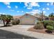 Charming single-story home with a two-car garage, mature landscaping, and a tile roof, set against a beautiful blue sky at 21675 N 61St Ave, Glendale, AZ 85308