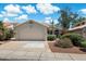 Charming single-story home with a two-car garage, mature landscaping, and a tile roof, set against a beautiful blue sky at 21675 N 61St Ave, Glendale, AZ 85308