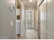 Hallway featuring tile flooring, neutral walls, closet, and nearby laundry at 21675 N 61St Ave, Glendale, AZ 85308