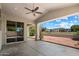 Spacious covered patio featuring a ceiling fan and providing views of a well-maintained backyard at 21675 N 61St Ave, Glendale, AZ 85308