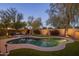 Backyard oasis featuring a sparkling pool, lounge area, lush landscaping, and putting green at 24121 N 24Th Pl, Phoenix, AZ 85024