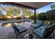 Inviting covered patio with comfortable seating overlooking sparkling pool and lush landscaping at 24121 N 24Th Pl, Phoenix, AZ 85024