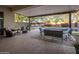 Spacious covered patio with multiple seating areas overlooking the pool and green putting space at 24121 N 24Th Pl, Phoenix, AZ 85024