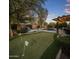 Beautiful backyard with putting green, pool, pergola, and lounge area perfect for entertaining at 24121 N 24Th Pl, Phoenix, AZ 85024