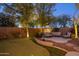 Relaxing backyard featuring putting green, mature trees, lounge area and custom landscaping at 24121 N 24Th Pl, Phoenix, AZ 85024