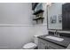 Stylish powder room featuring a gray vanity, decorative shelves and updated fixtures at 24121 N 24Th Pl, Phoenix, AZ 85024