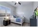 Cozy bedroom with a comfortable bed, plush carpet, bright window and modern furnishings at 24121 N 24Th Pl, Phoenix, AZ 85024