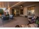 Spacious covered patio featuring comfortable seating, an outdoor ceiling fan, and views of the backyard at 24121 N 24Th Pl, Phoenix, AZ 85024