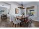 Dining room with wood table and chairs, bench seating, and large window, perfect for Gathering gatherings at 24121 N 24Th Pl, Phoenix, AZ 85024
