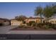 Home exterior featuring well-manicured landscaping, mature trees, and a well-lit facade at 24121 N 24Th Pl, Phoenix, AZ 85024
