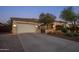 Exterior shot of home showcasing a well-maintained yard and spacious driveway and 2-car garage at 24121 N 24Th Pl, Phoenix, AZ 85024