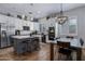 Modern kitchen with stainless steel appliances, white cabinets, and a central island with bar seating at 24121 N 24Th Pl, Phoenix, AZ 85024