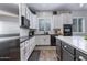 Contemporary kitchen featuring white cabinets, black countertops and stainless steel appliances, stylish and functional at 24121 N 24Th Pl, Phoenix, AZ 85024