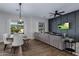 Bright open-concept living and dining area boasts wood floors and elegant decor at 24121 N 24Th Pl, Phoenix, AZ 85024