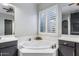 Luxurious bathroom featuring a soaking tub with dual vanities and a large window at 24121 N 24Th Pl, Phoenix, AZ 85024